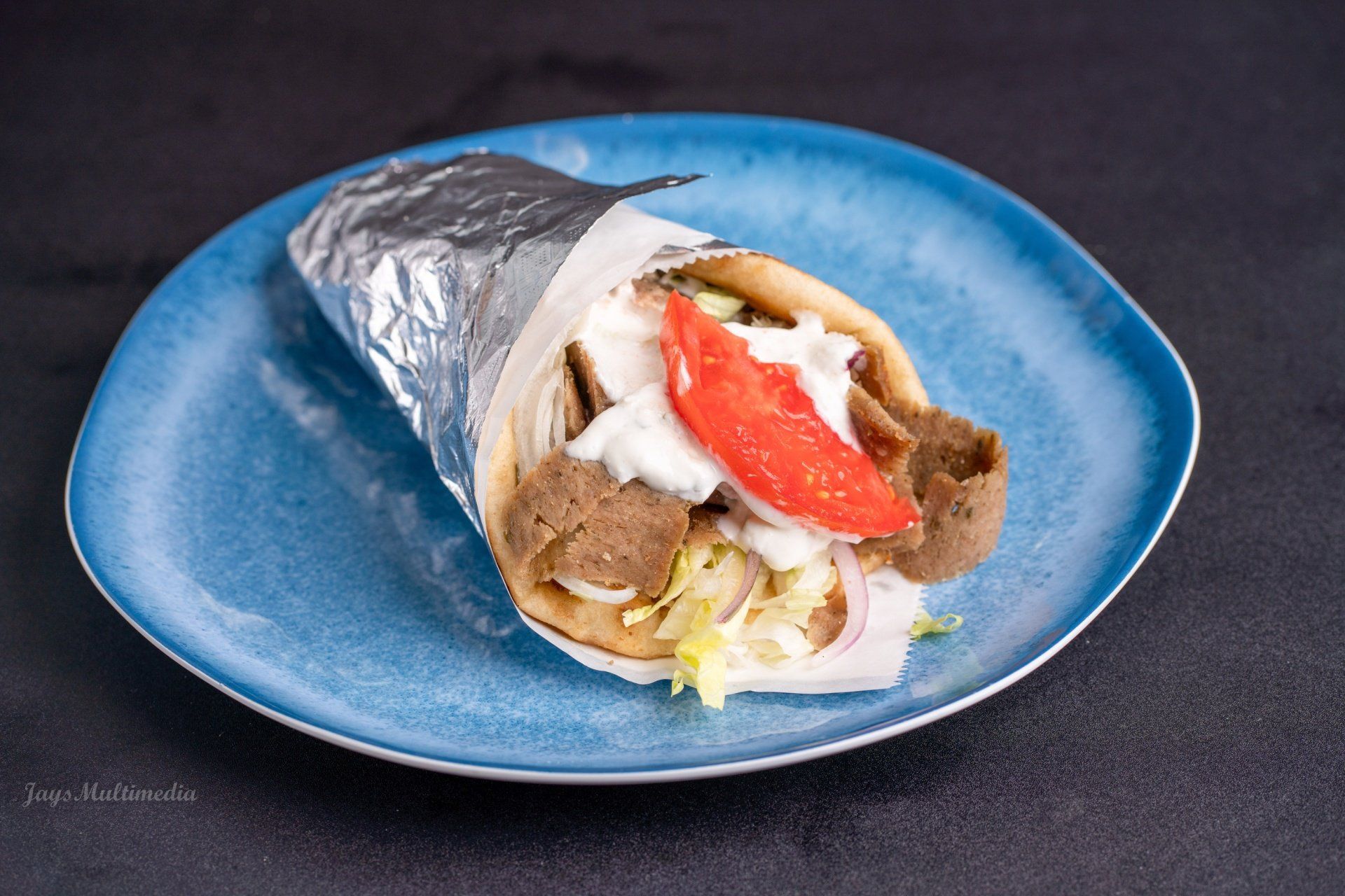 A close up of a gyro on a blue plate