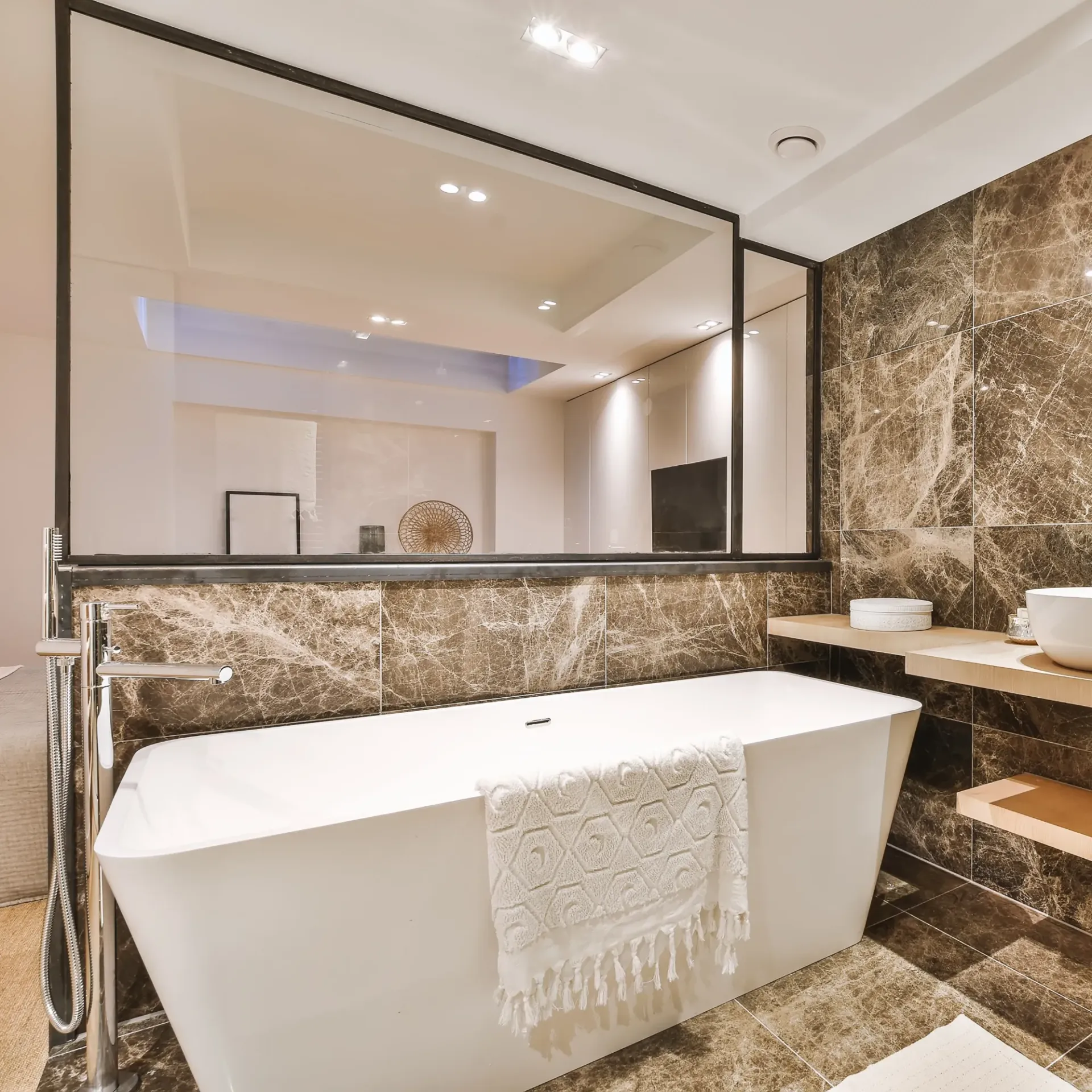 Sanchez Electric and Remodeling - A bathroom with a bathtub and a large mirror