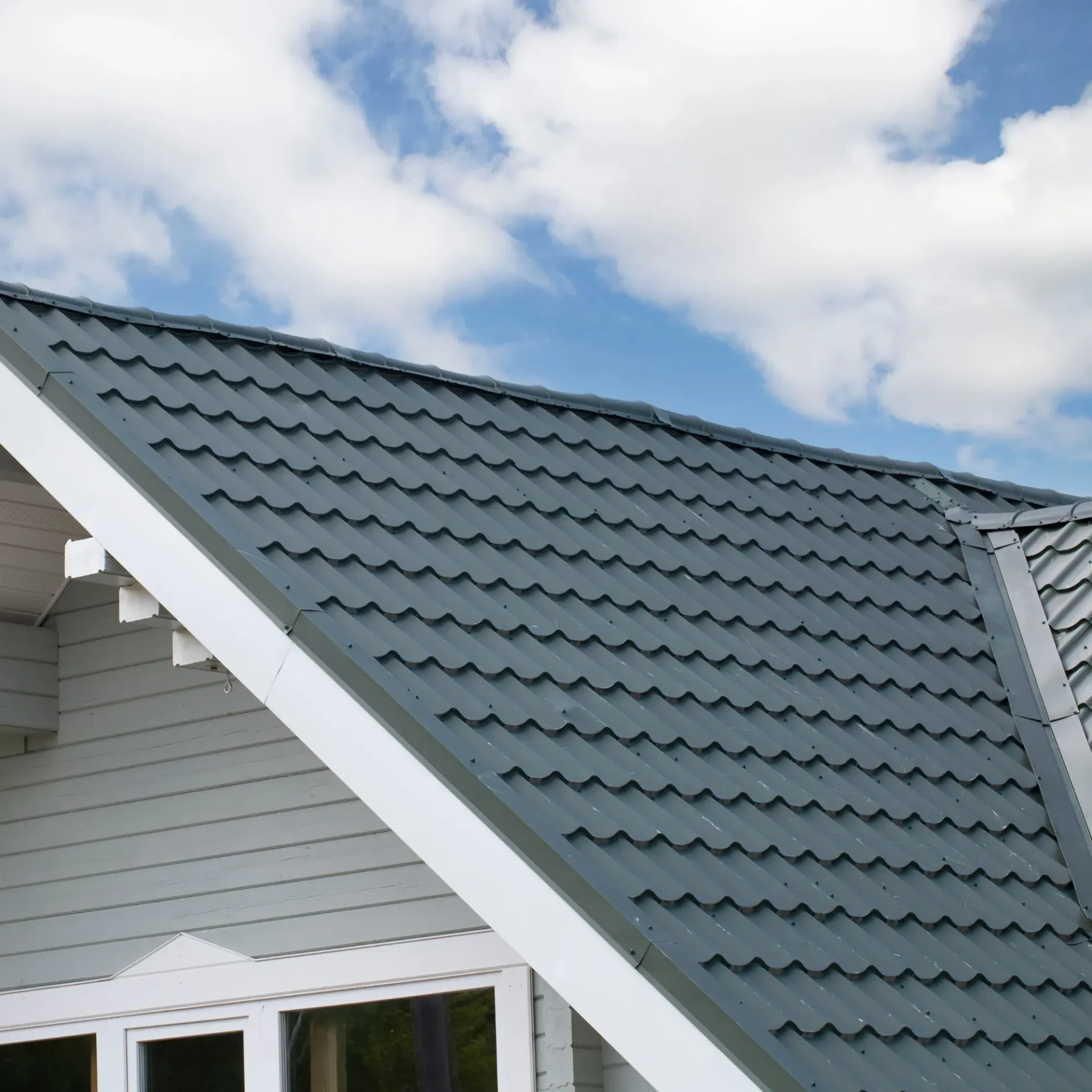 Sanchez Electric and Remodeling - A roof of a house with a blue sky in the background