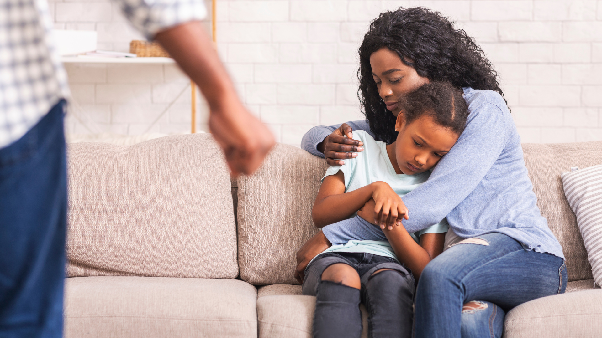 A lawyer is shaking hands with a client while sitting at a desk.