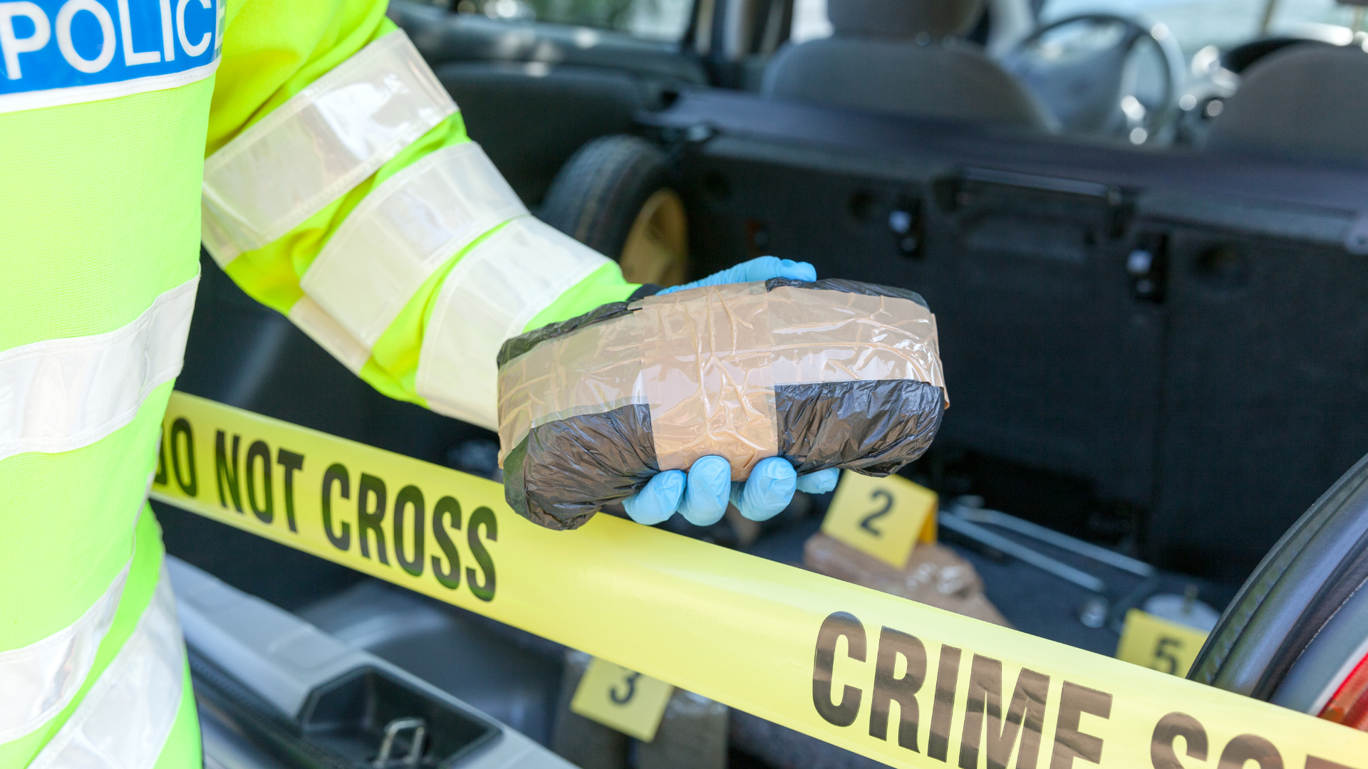 A judge 's gavel is sitting on a wooden table in front of a group of people.