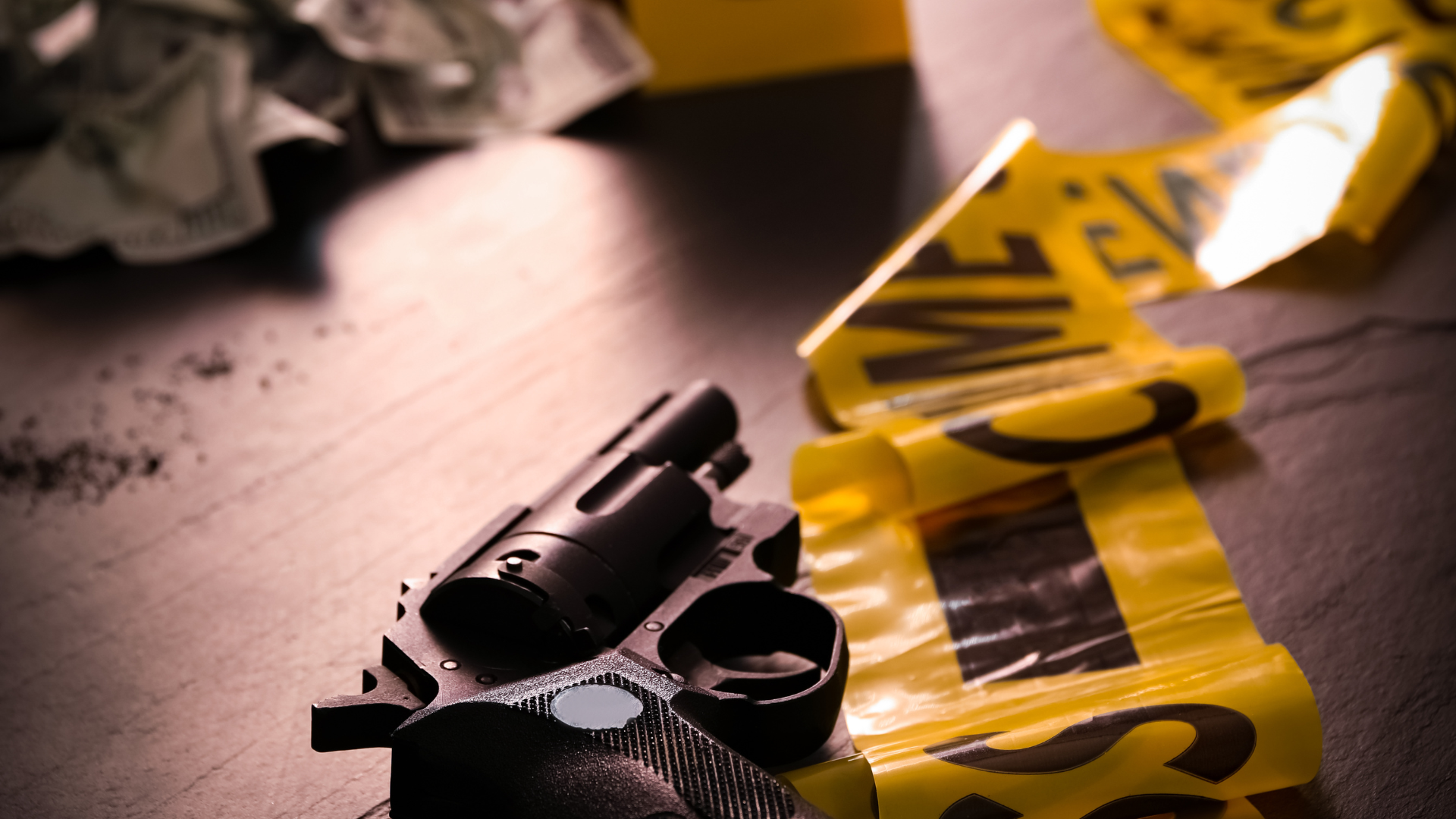 A judge is sitting at a table with a book and a gavel.
