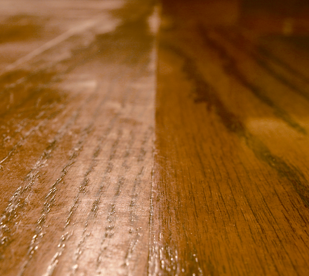 A close up of a wooden table with a diagonal line between two pieces of wood.