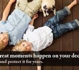 A man and a child are laying on the floor with their dogs.