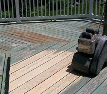 A wooden deck with a fence and a machine on it.