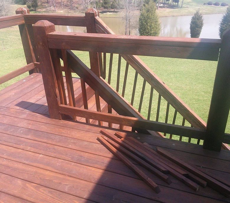 A wooden deck with stairs leading up to a lake