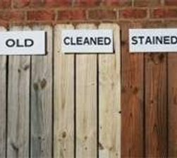 A row of wooden fences with signs that say old , cleaned , and stained.