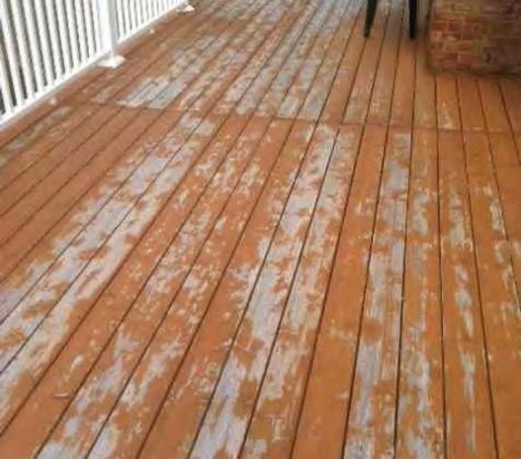 A wooden deck with peeling paint and a white railing.