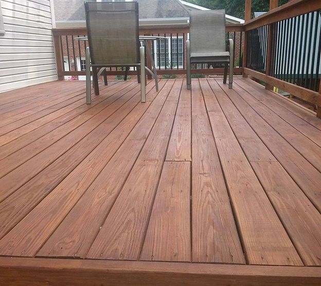 A wooden deck with a table and chairs on it