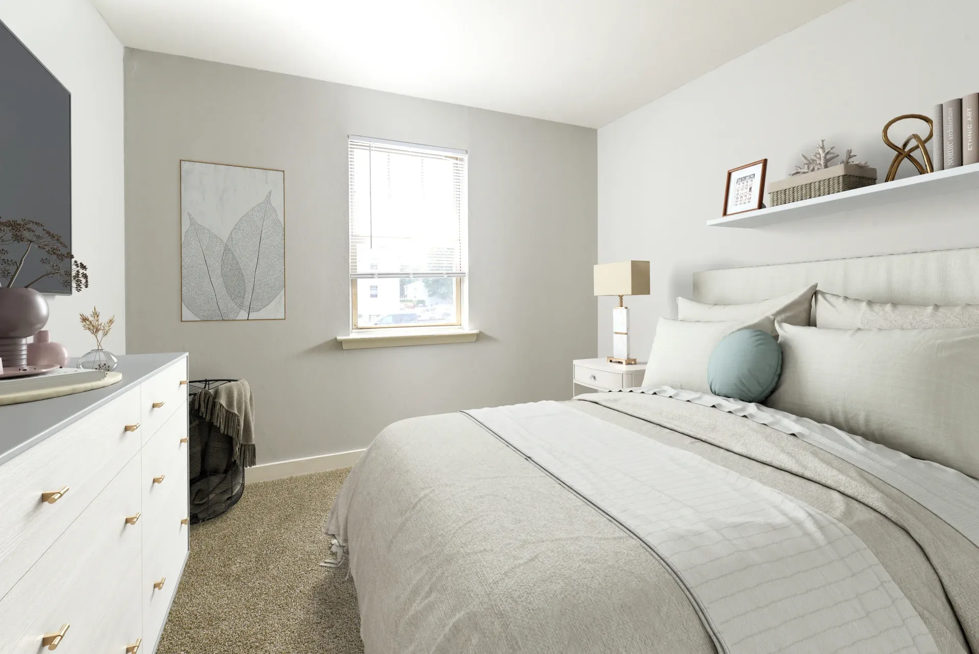 Bedroom interior with a large bed, white dresser, and a window letting in light.