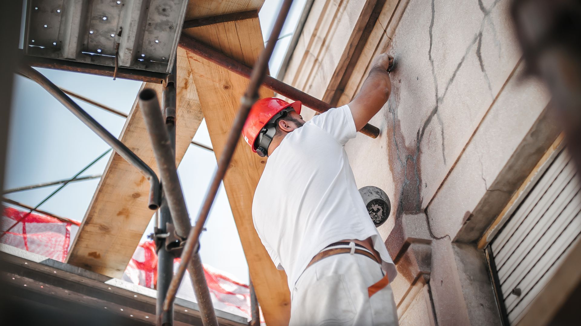 A construction worker wearing a red hard hat