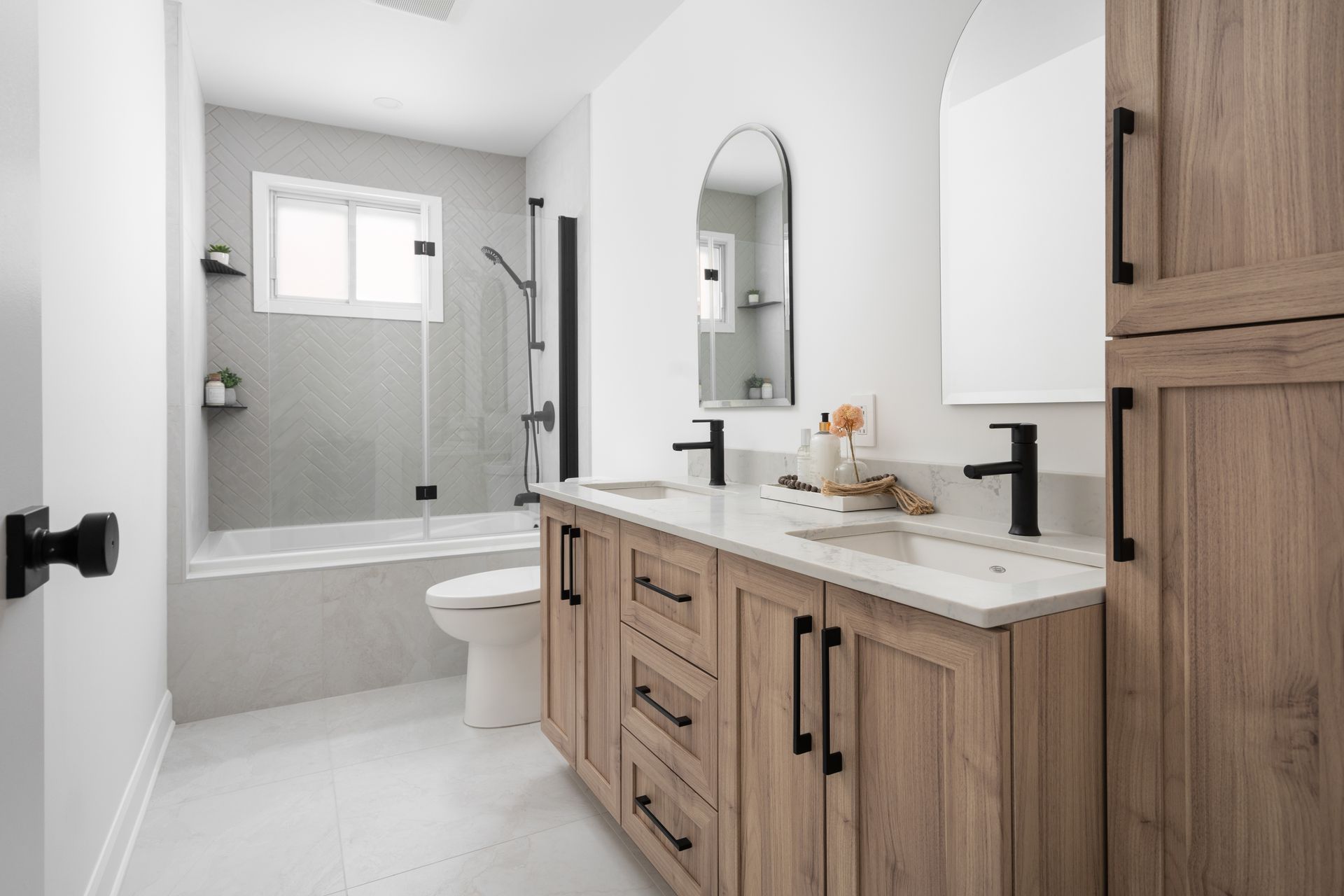 A modern bathroom with a light wood vanity