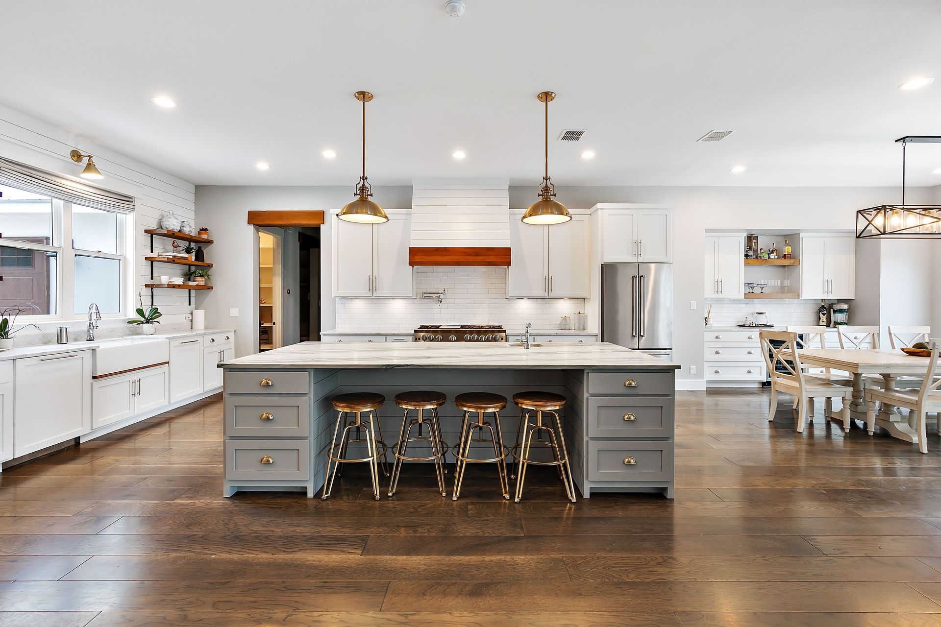 Modern kitchen with gray island and white cabinets