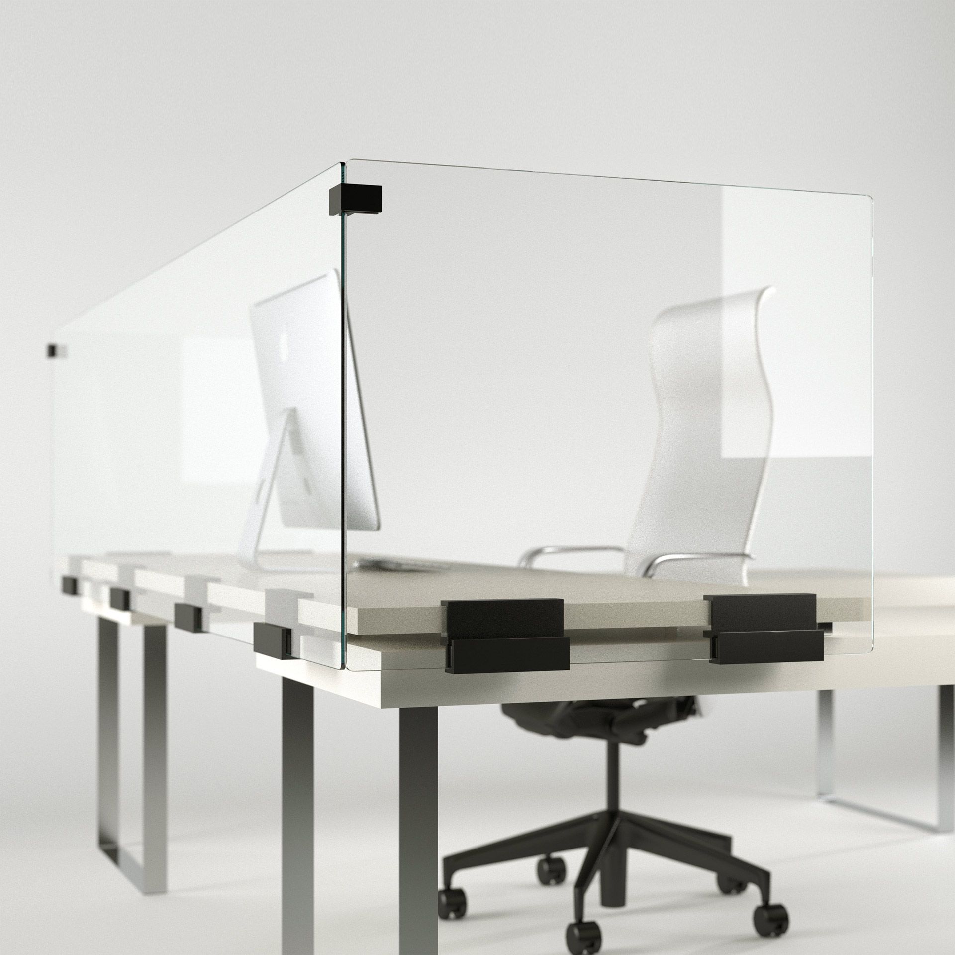 A desk with a glass divider and a computer on it