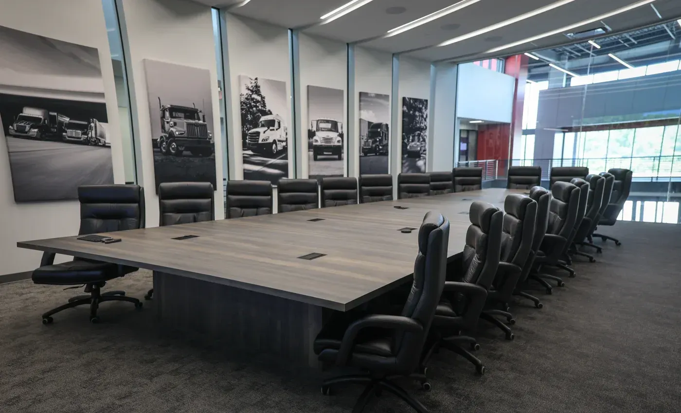 A conference room with a long table and chairs
