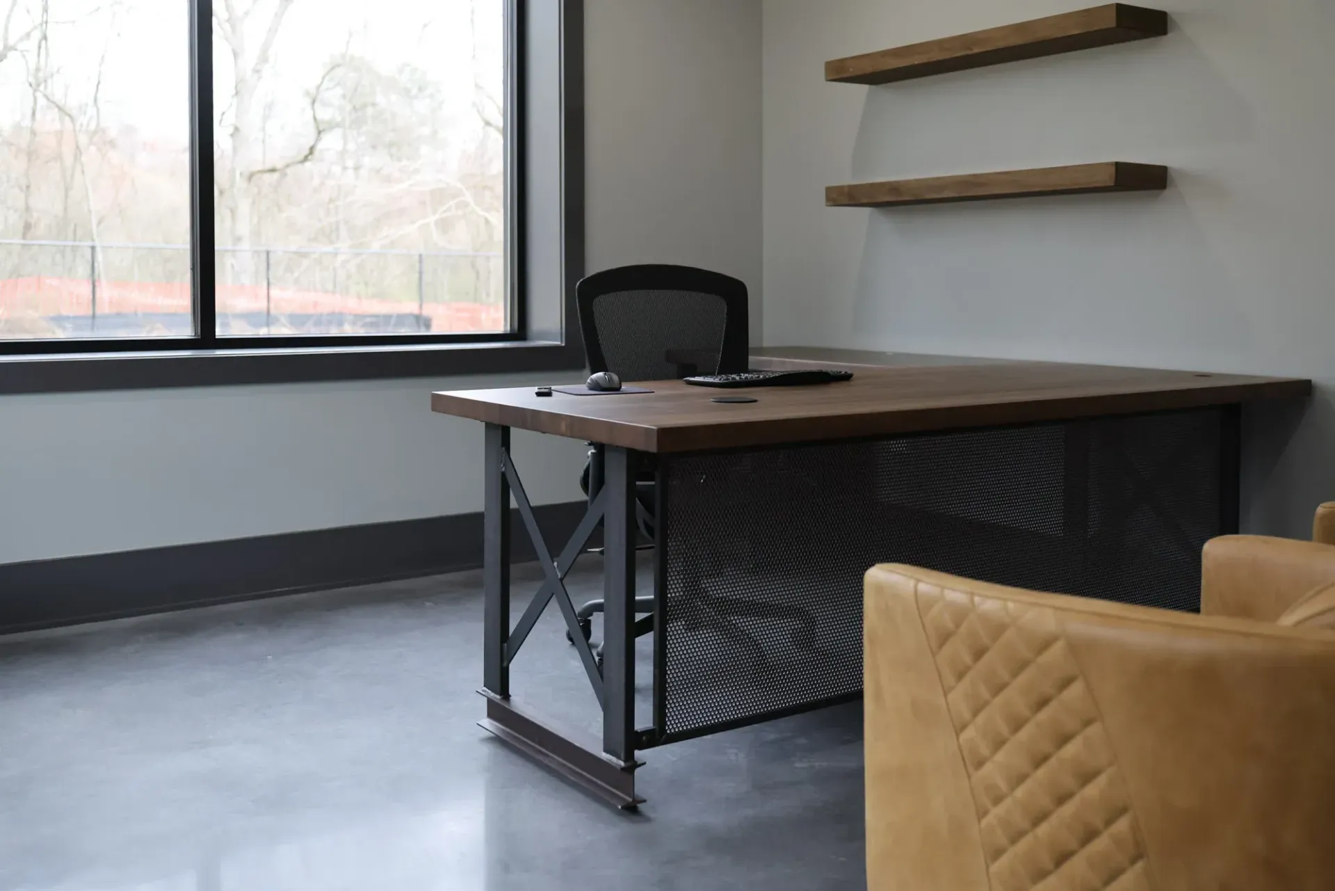 There is a desk and chair in the room.