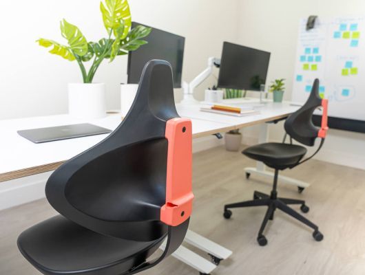 Two chairs are sitting next to each other in an office.