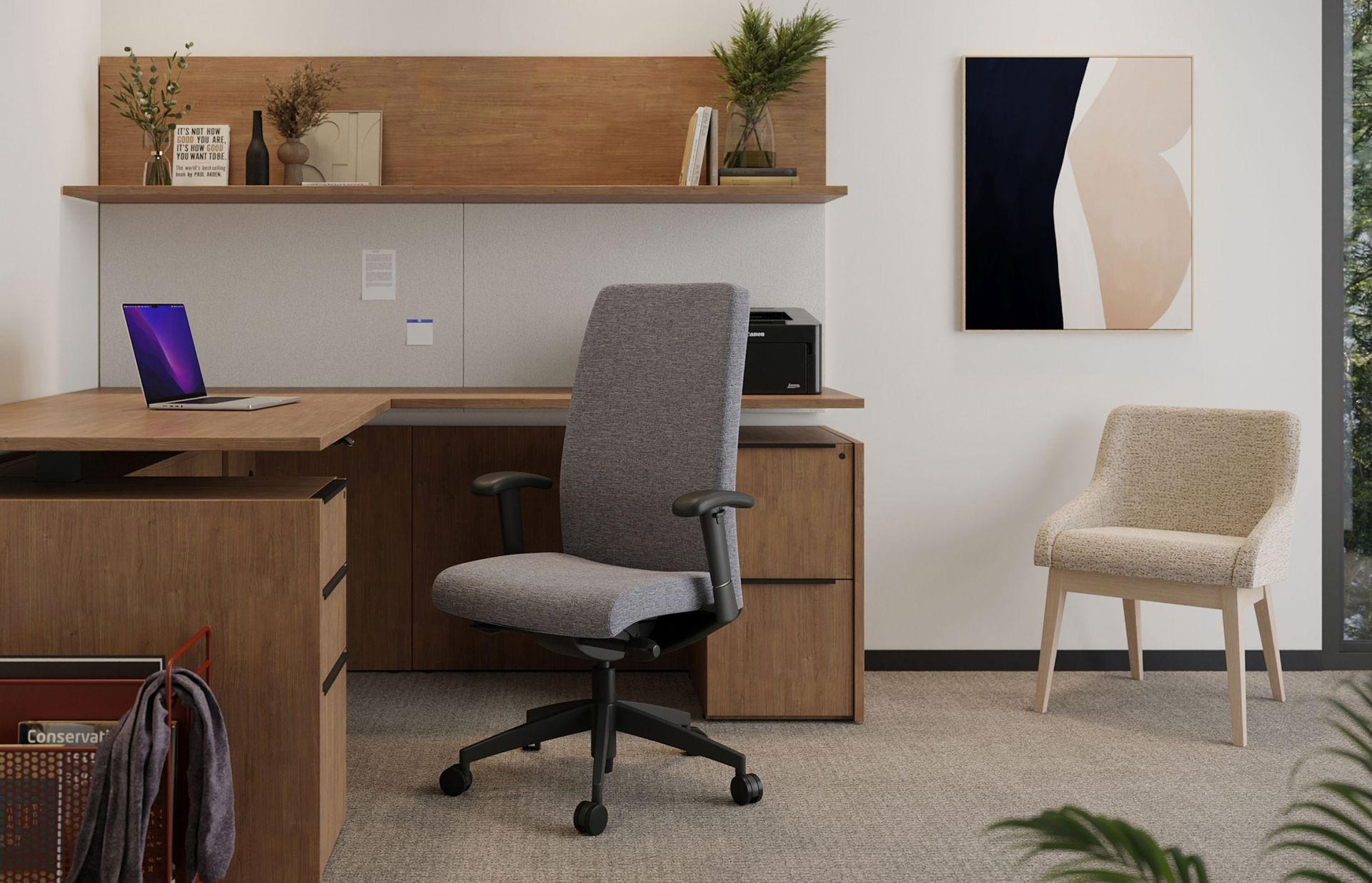 A home office with a desk , chair , laptop and painting on the wall.