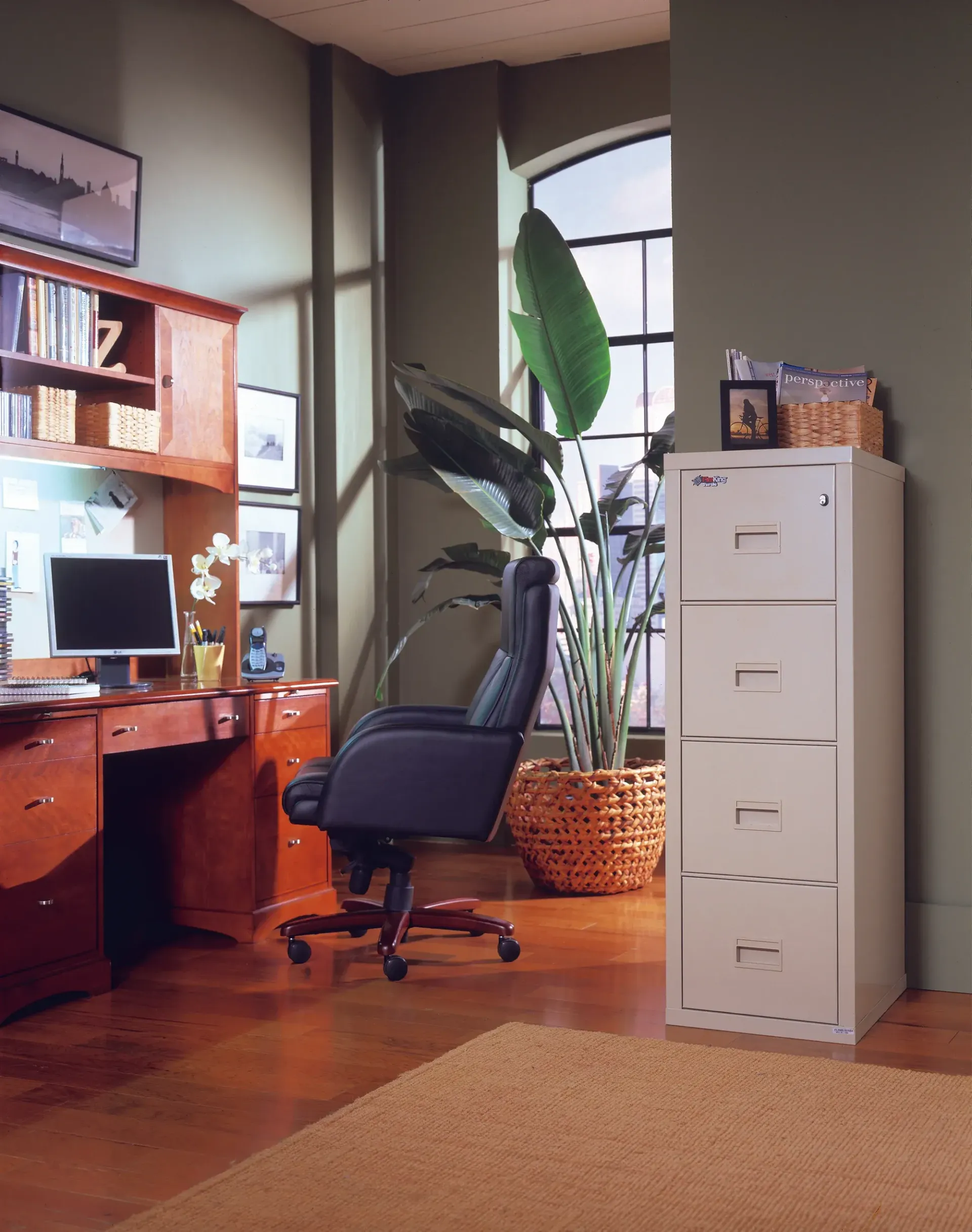 A home office with a filing cabinet and a chair