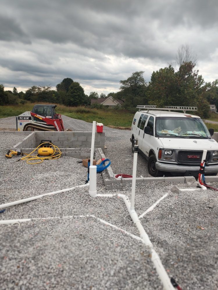 Person wearing gloves using a wrench to work on a metal object, likely in a kitchen.