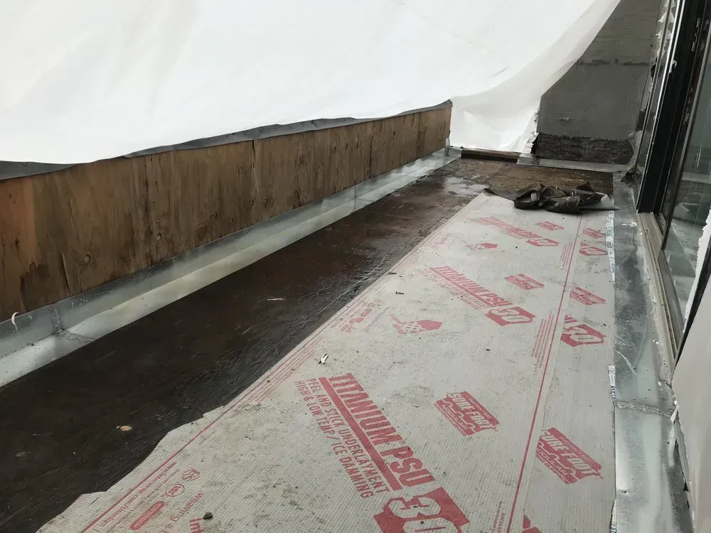 Construction scene: wood and metal on a roof, covered with waterproof material.