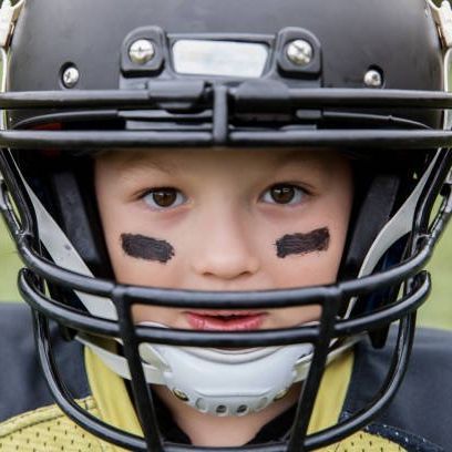 Kid with football helmet