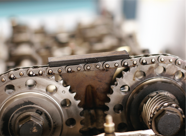 A close up of a chain and gears on a machine