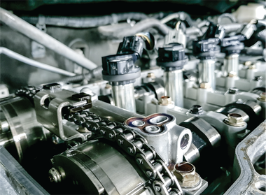 A close up of a car engine with the hood open.