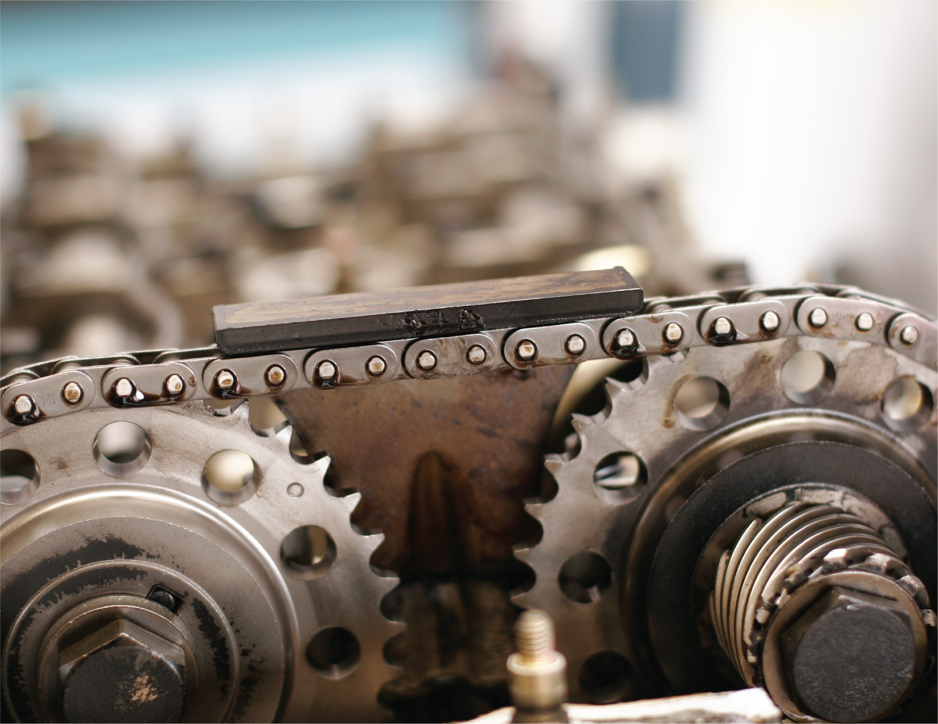 A close up of a chain and gears in a machine