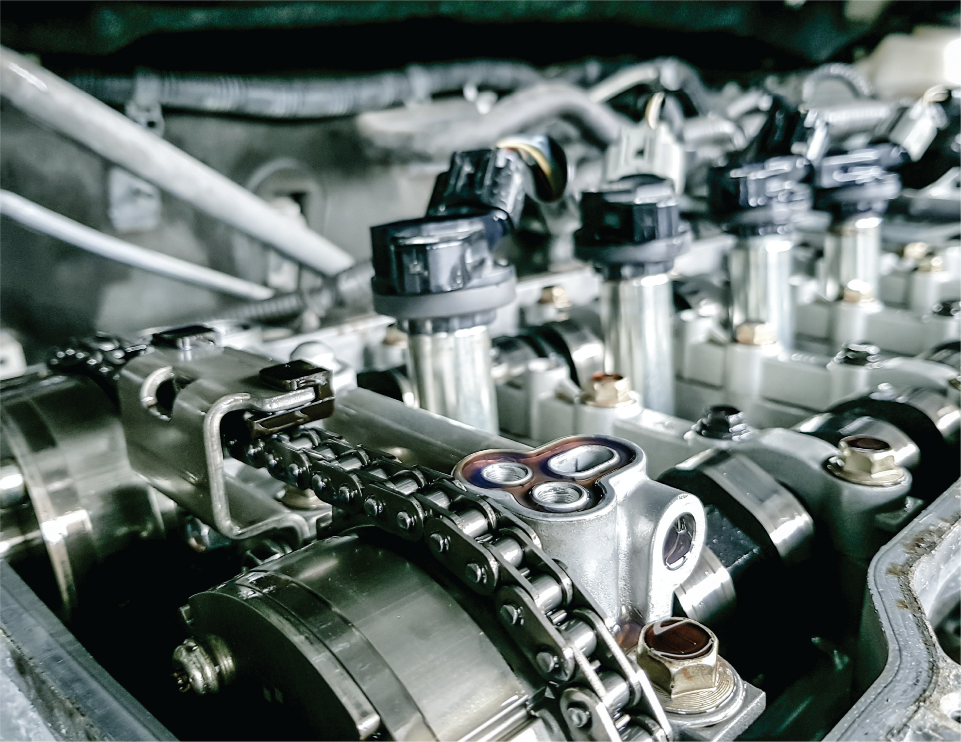 A close up of a car engine with a chain.
