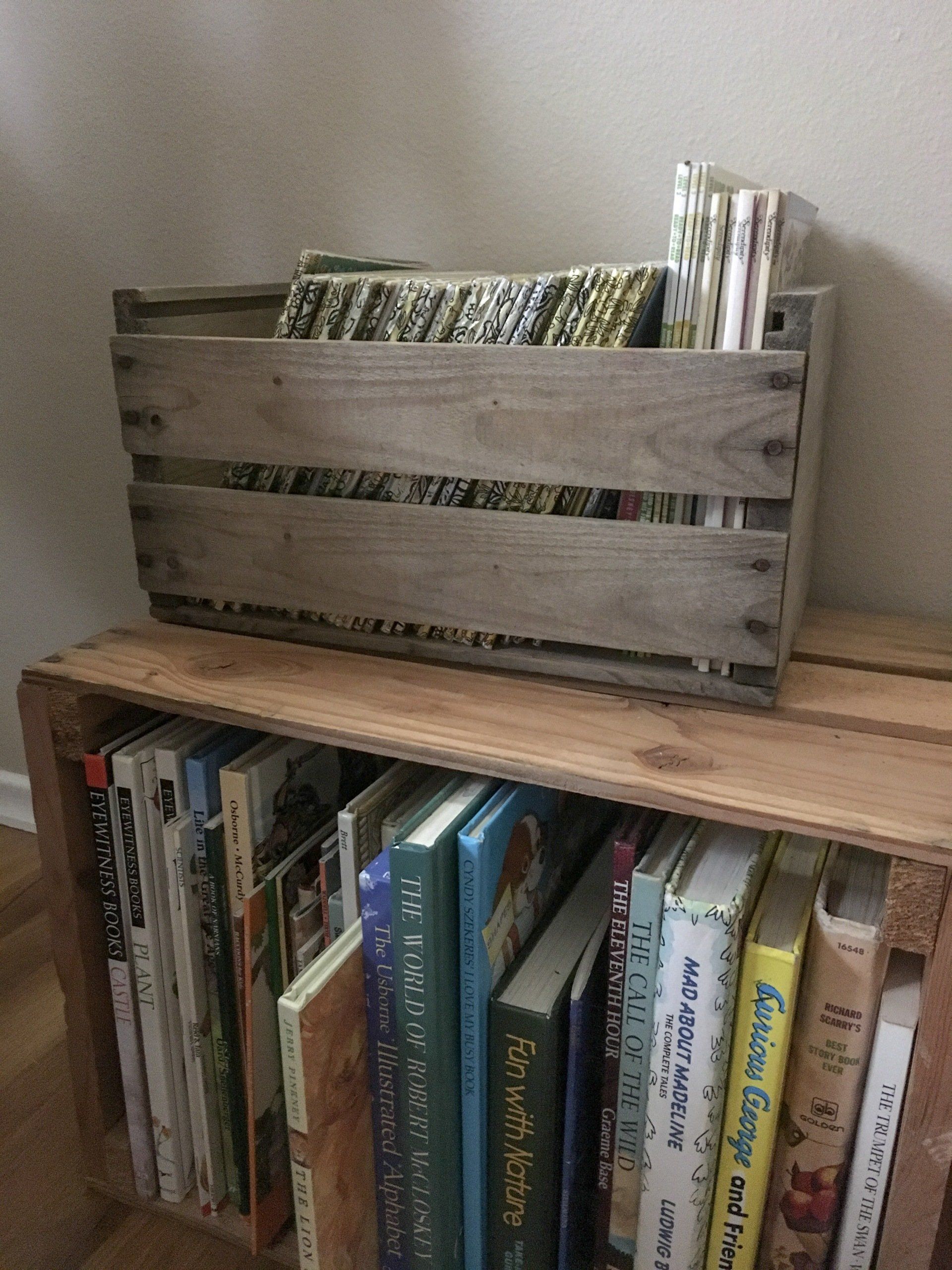 Our Wild One’s reading nook made up of wood crates.
