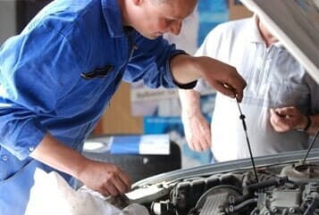 Mechanic Checking the Vehicle's Oil Level - Auto Maintainance