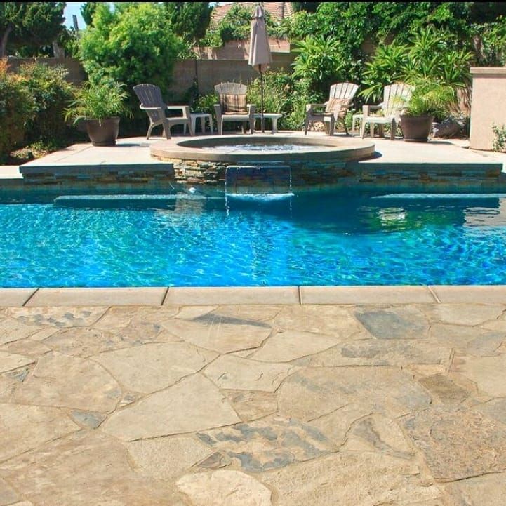 Interior of a modern kitchen under renovation; light wood cabinets, light blue accents, person working, construction debris.