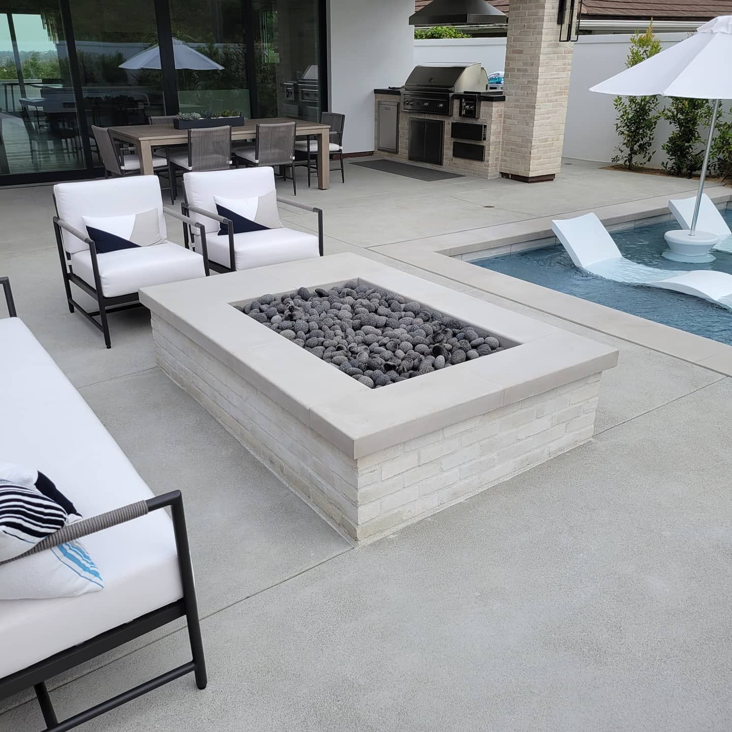 Building exterior under construction with red metal roof frame and white walls, door and windows.