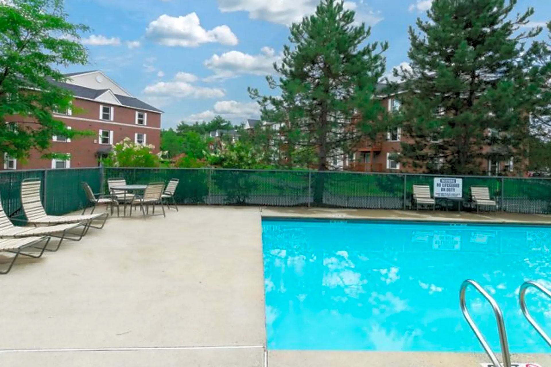 Swimming pool and poolside seating at Penacook Place Apartments.