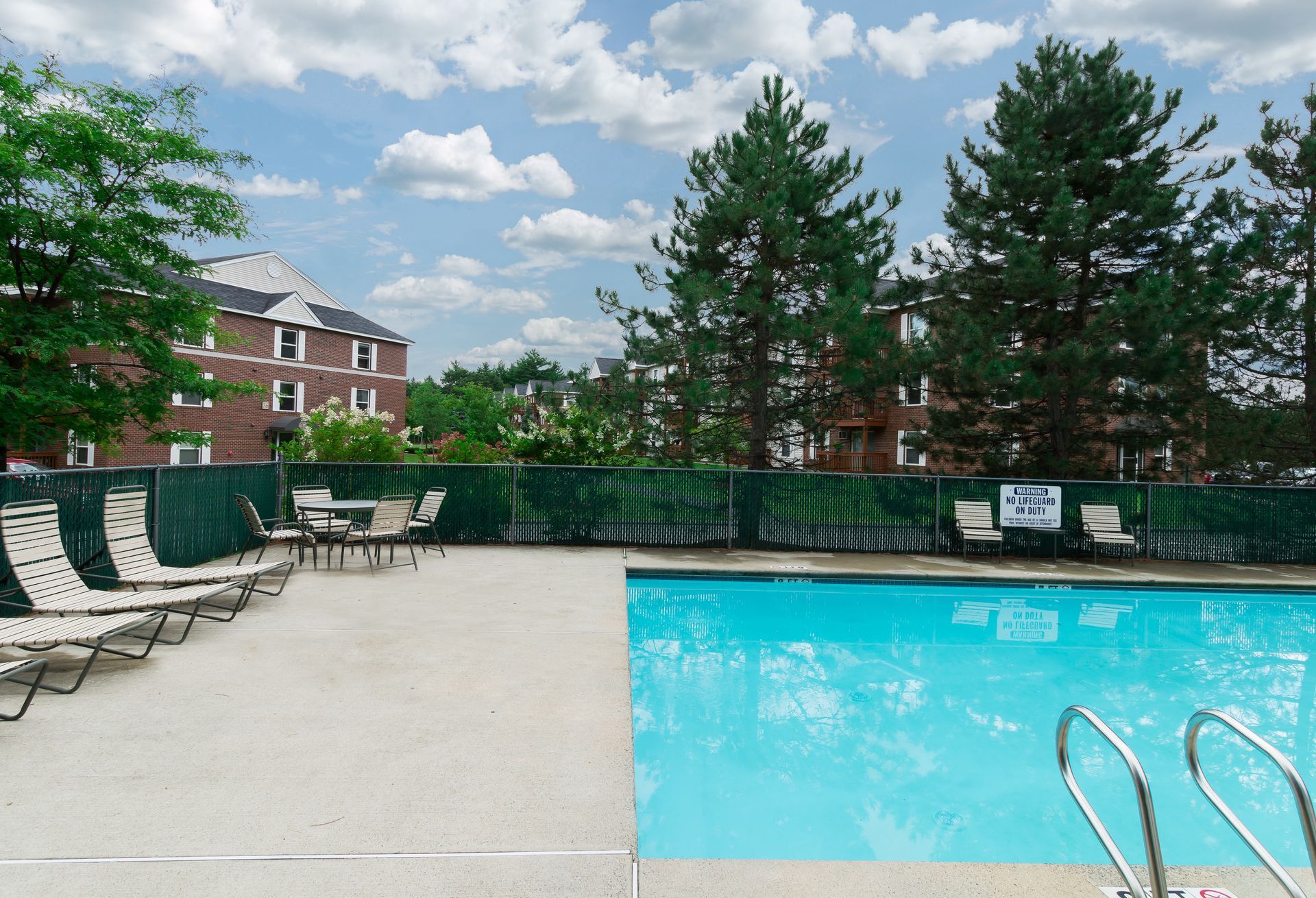 Swimming pool and poolside seating at Penacook Place Apartments.