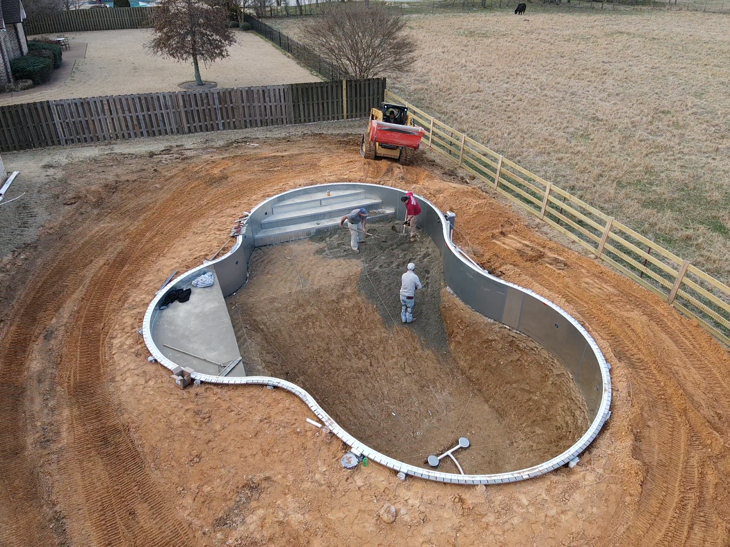 A child is swimming in a swimming pool with an inflatable ring.