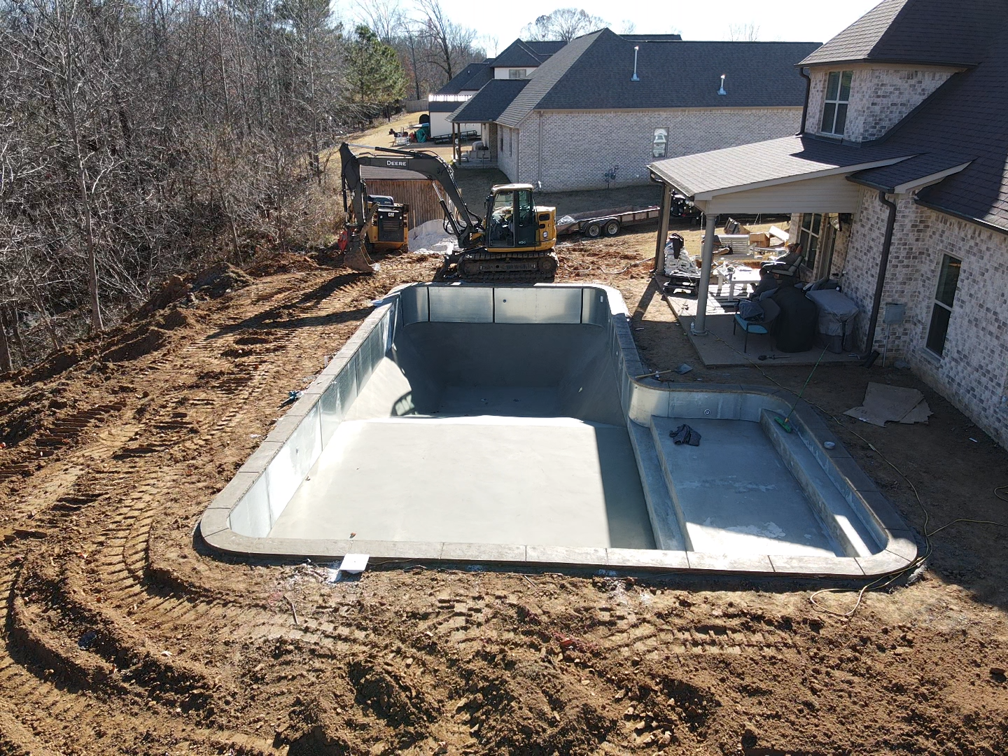 An aerial view of a large swimming pool with two lounge chairs in it.