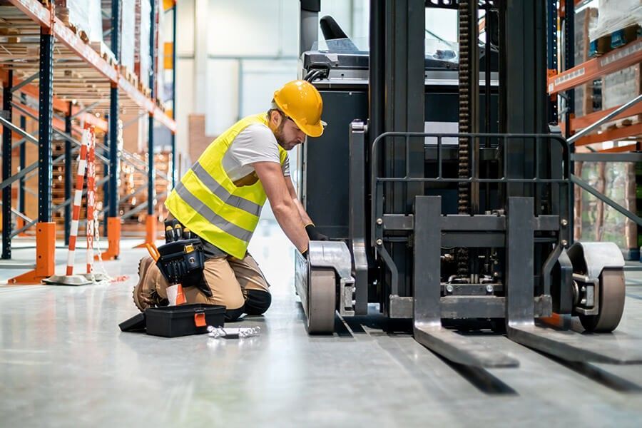 Technician Repairing a Forklift