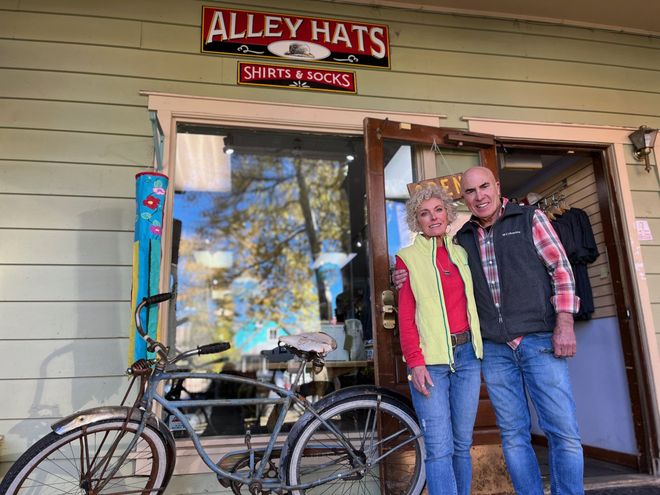 Scott and trixie standing in front of alley hats store
