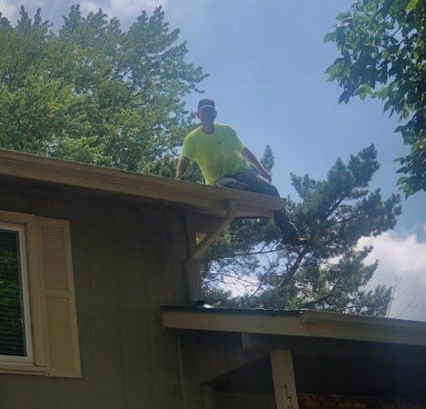 Man on Roof Cleaning Gutter – Omaha, NE – Loberg & Sons Gutter Cleaning