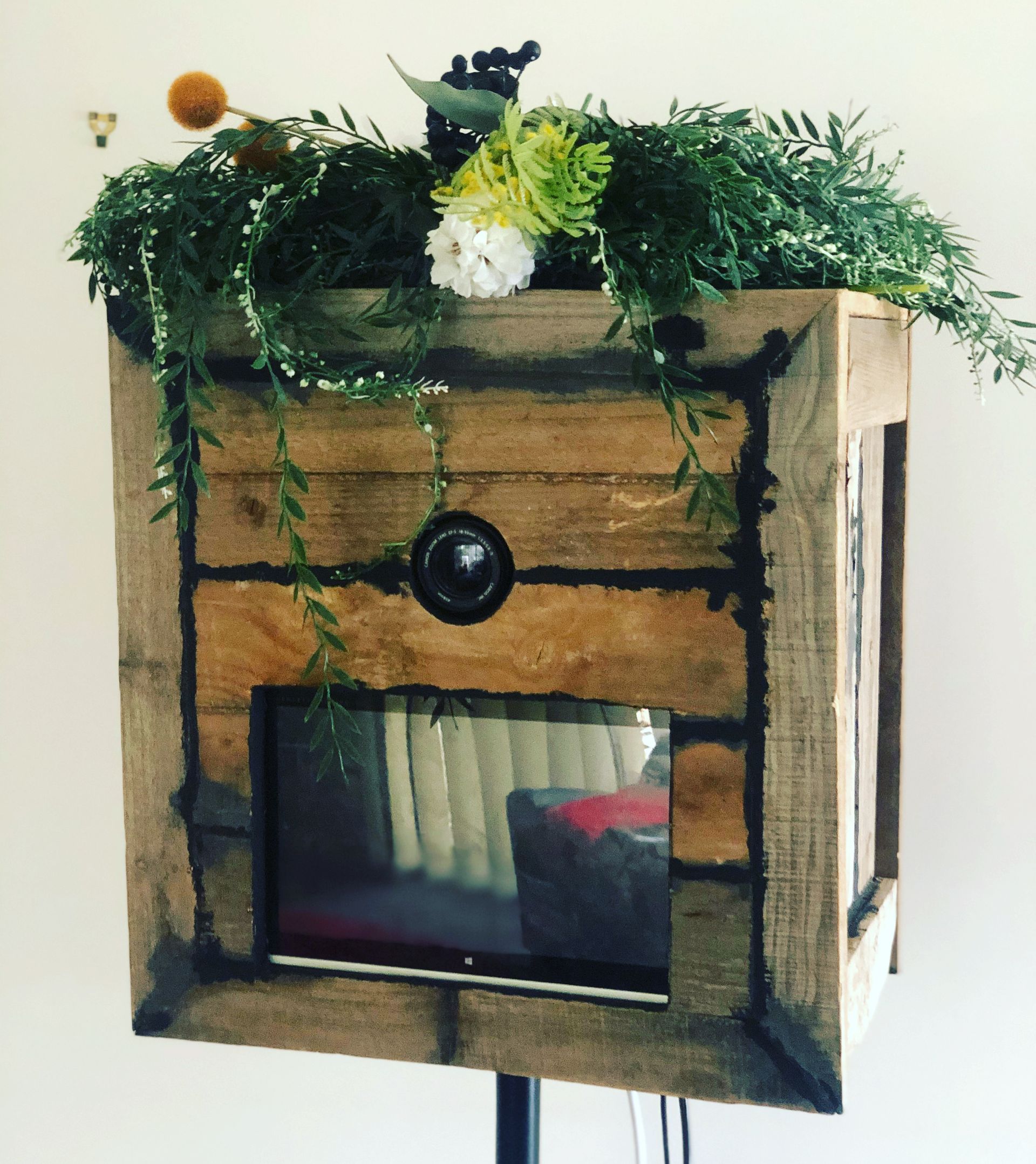 A wooden box with flowers on top of it