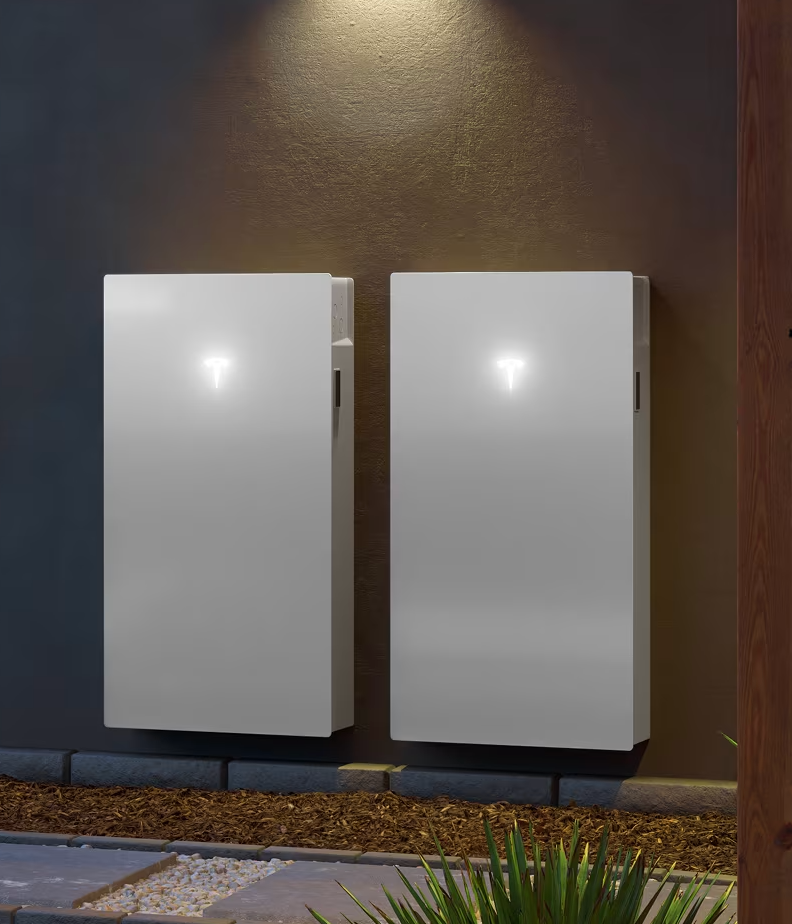 A person installing a solar panel on a gray corrugated metal roof.