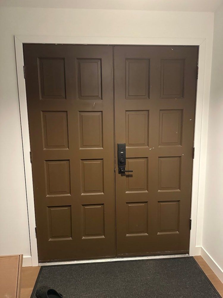 a pair of brown doors with a black door knob