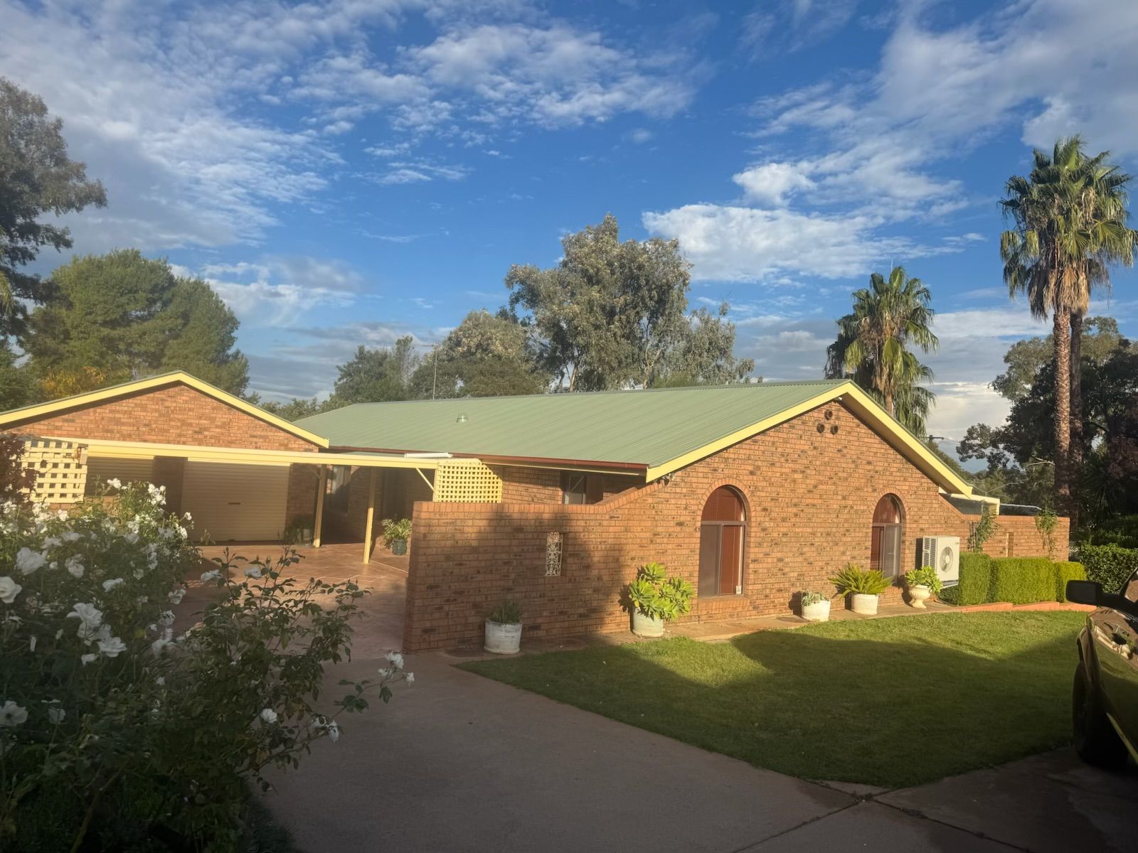 Brick Suburban House With Green Roof, Driveway, Lawn, and Blue Sky — Robert Seeliger Painter And Decorator in Mudgee, NSW