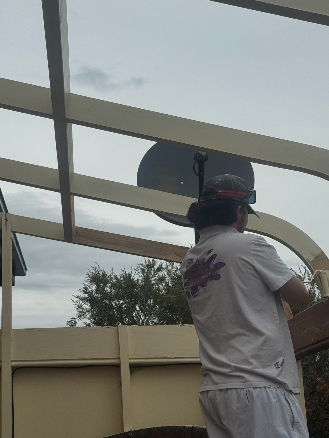 Person in a Hat Working on a White Metal Frame Outdoors — Robert Seeliger Painter And Decorator in Mudgee, NSW