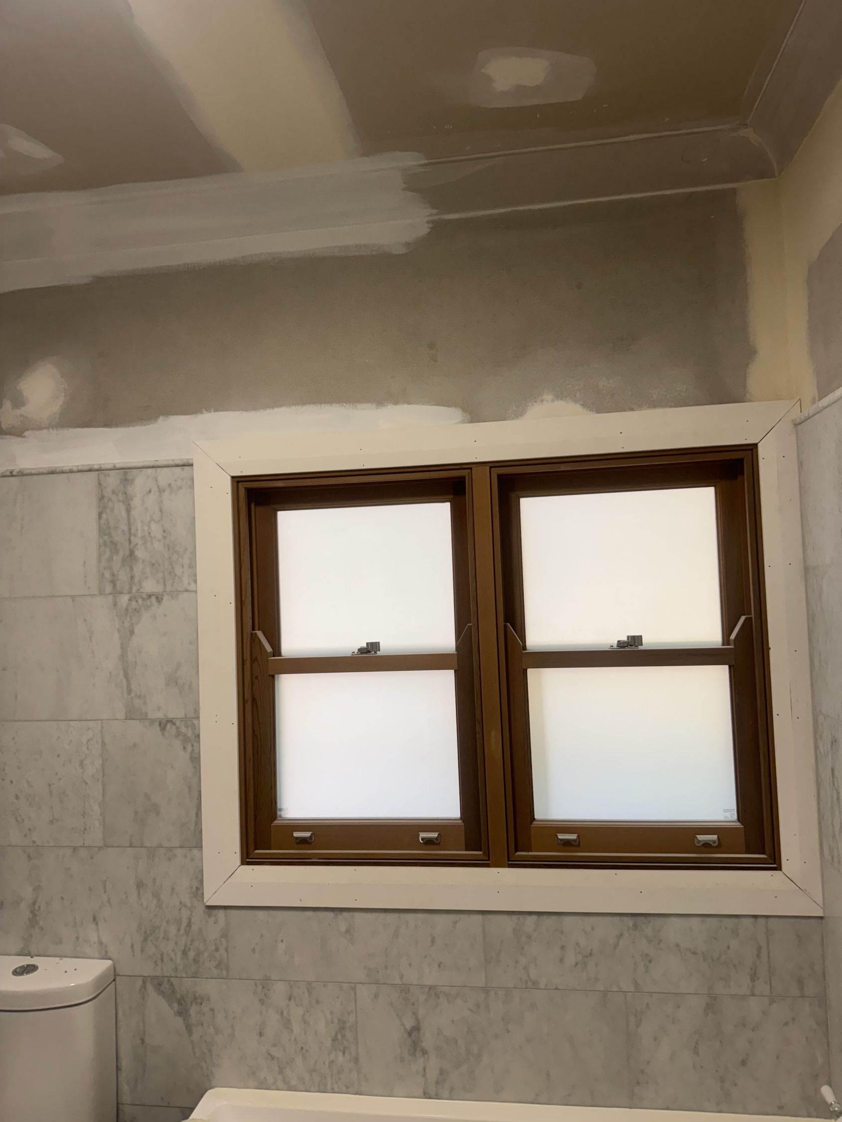 Bathroom With Unfinished Gray Walls, a Small Wooden-framed Window — Robert Seeliger Painter And Decorator in Dubbo, NSW