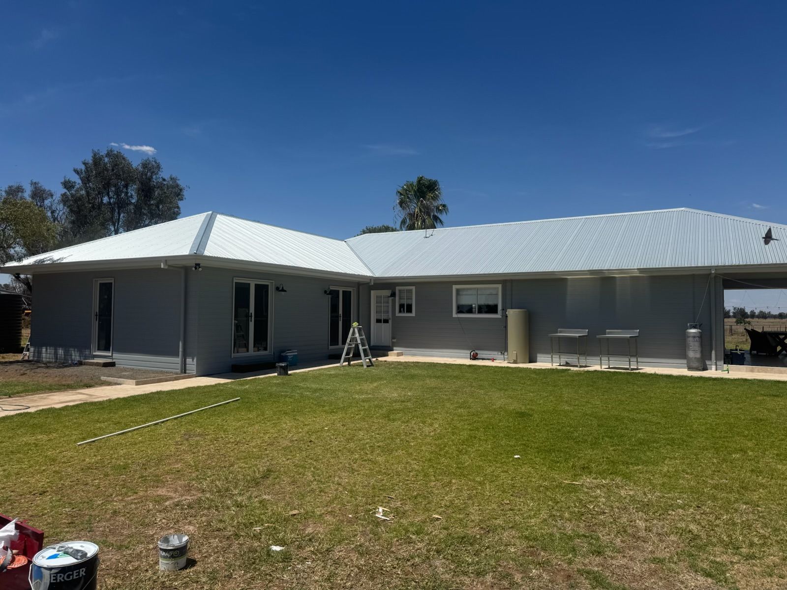 Single-story Gray House With White Metal Roof and Grassy Yard — Robert Seeliger Painter And Decorator in Warren, NSW