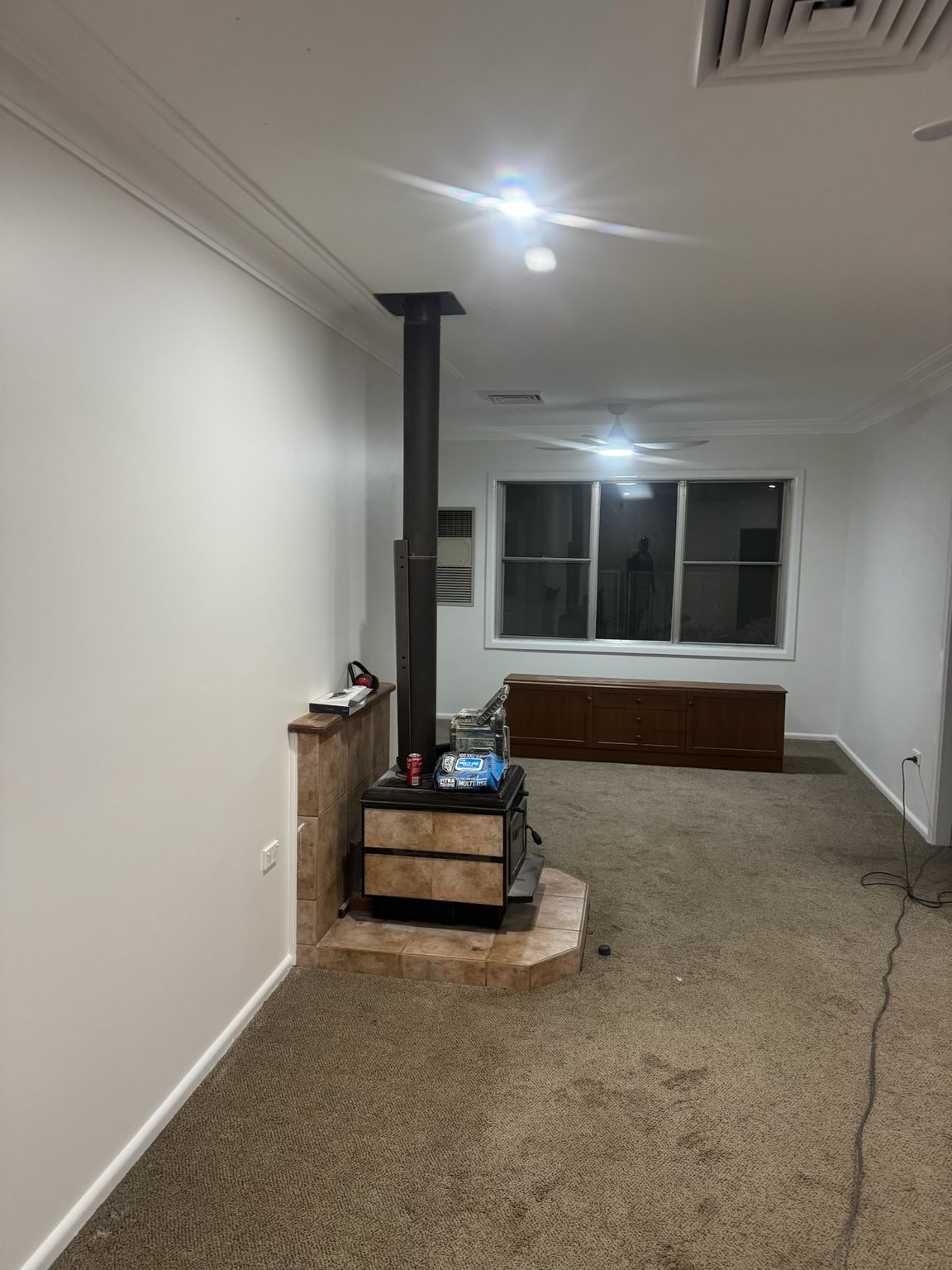 Empty Room With Beige Carpet, White Walls, and a Window at the Far End — Robert Seeliger Painter And Decorator in Mudgee, NSW