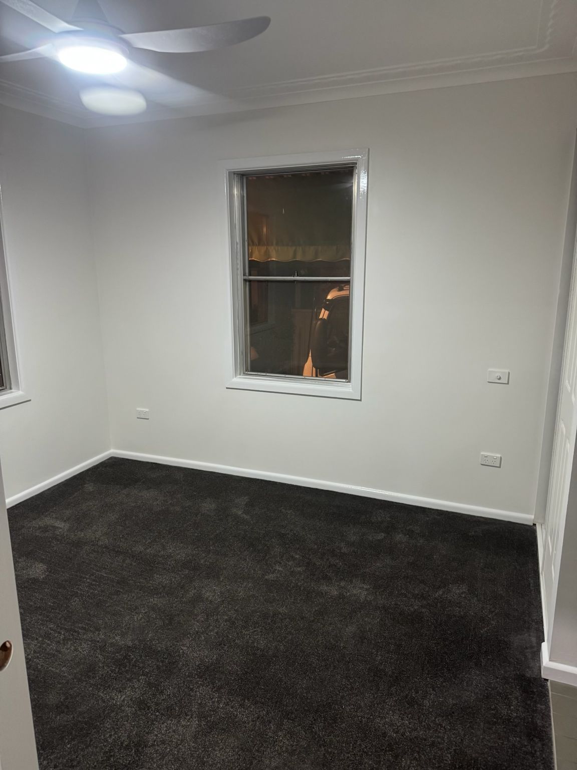 Empty White Room With Dark Carpet and a Window Showing Night Outside — Robert Seeliger Painter And Decorator in Mudgee, NSW